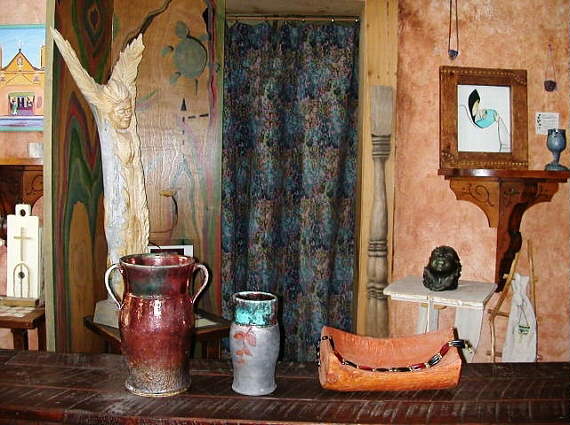 Front entry display, painted wooden screen, pottery, sculpture.